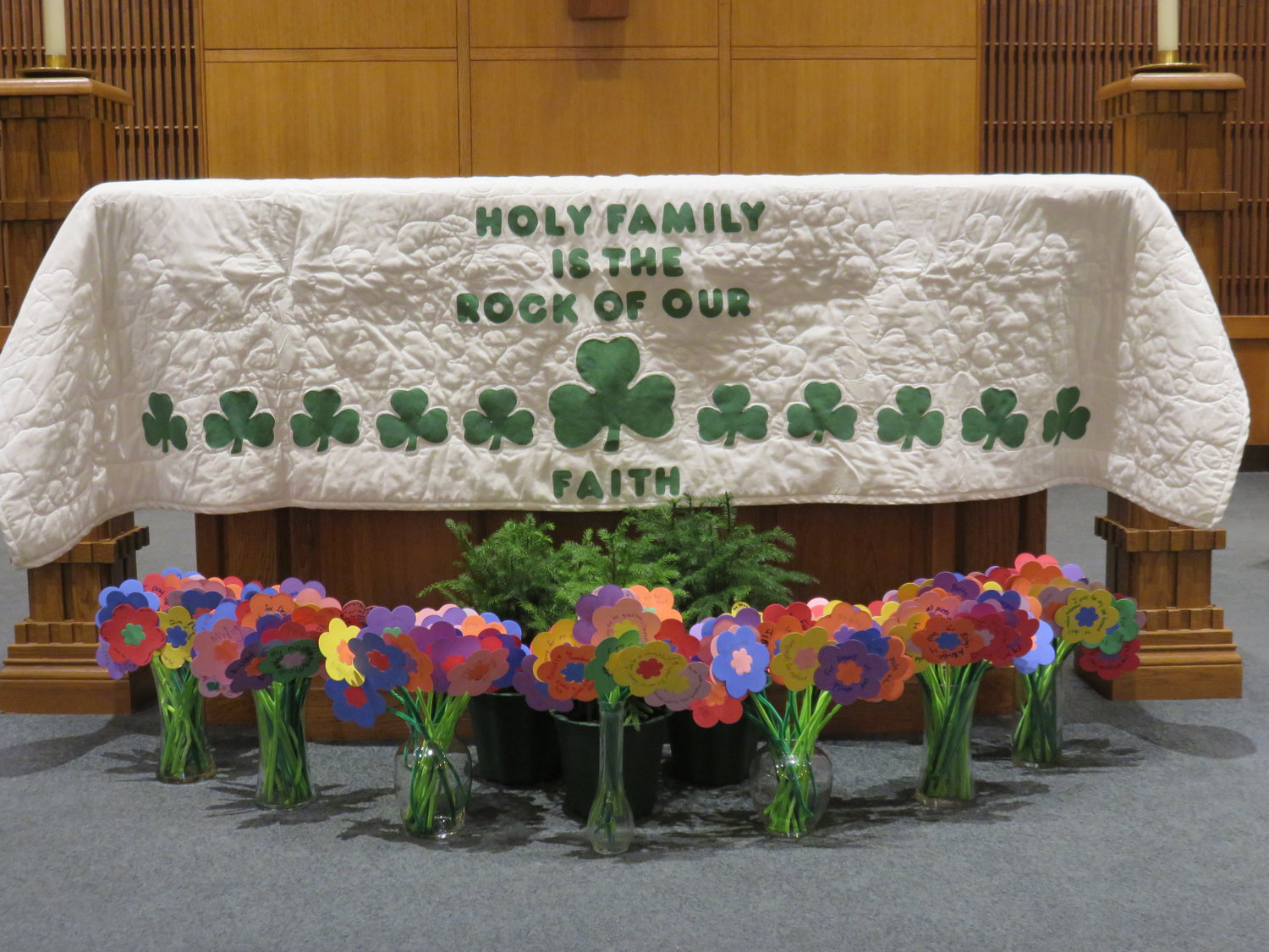 Prayer bouquets made of students' prayers written on colored paper adorn the sanctuary of Holy Family Church during a Catholic Schools Week celebration of prayer.